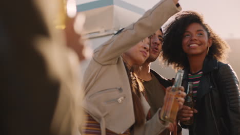 happy rooftop party friends having fun young asian woman taking group photos using smartphone sharing weekend lifestyle on social media at sunset