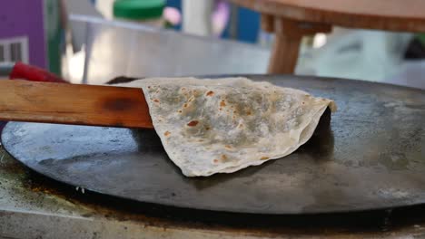 cooking traditional turkish gözleme on a griddle