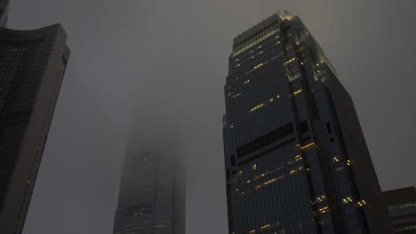 mist surrounding hong kong skyscrapers