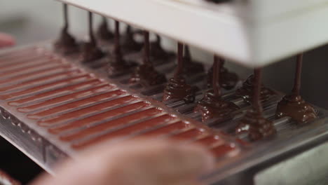 filling bakery confectionary mold with dark chocolate