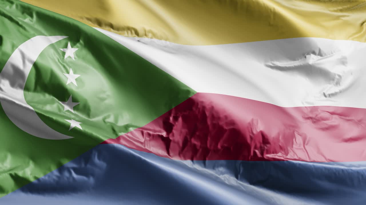 la bandera de las comoras ondeando en el bucle del viento. la bandera comoriana balanceándose en la brisa. fondo de relleno completo. bucle de 10 segundos.
