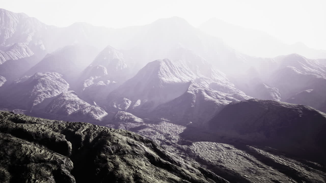 Majestic mountains stretch across the horizon enveloped in a gentle mist