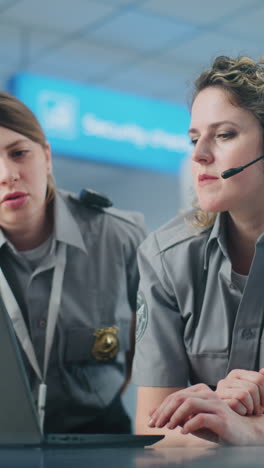 airport security personnel reviewing information