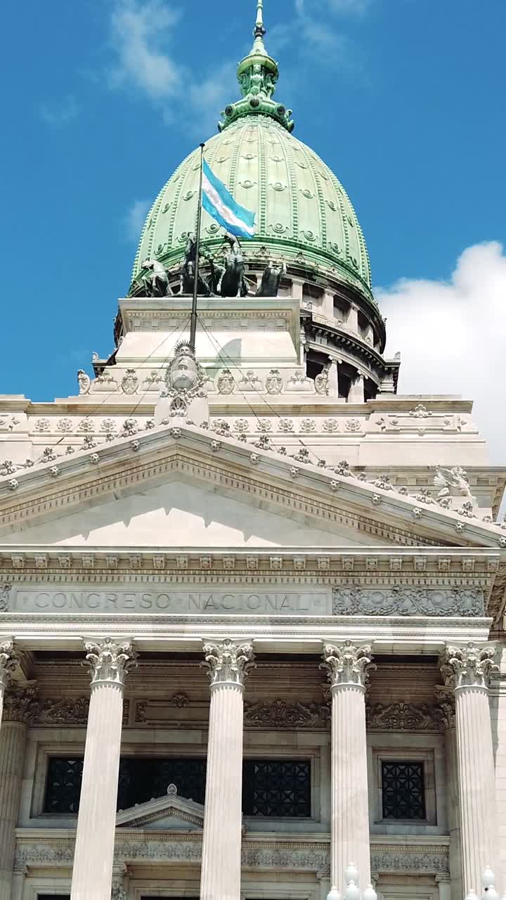 Vertical view of the National congress building over daylight Skyline, Argentine flag