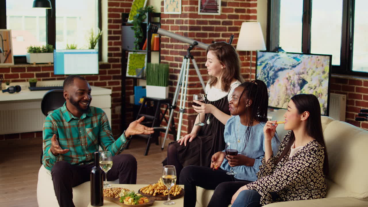 BIPOC group of friends discussing at home, gathered together for birthday party