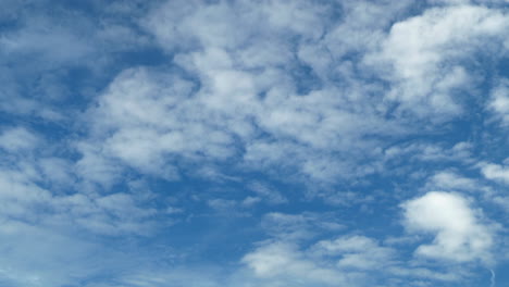 white puffy clouds and a blue clear sky timelapse