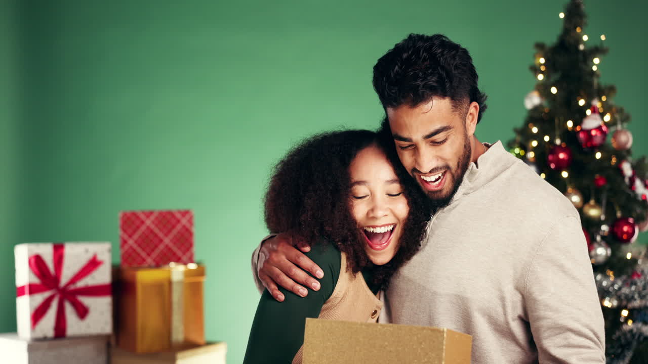 Couple opening Christmas gifts