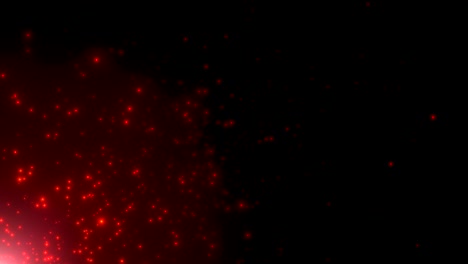 pequeñas partículas rojas y estrellas en fondo oscuro
