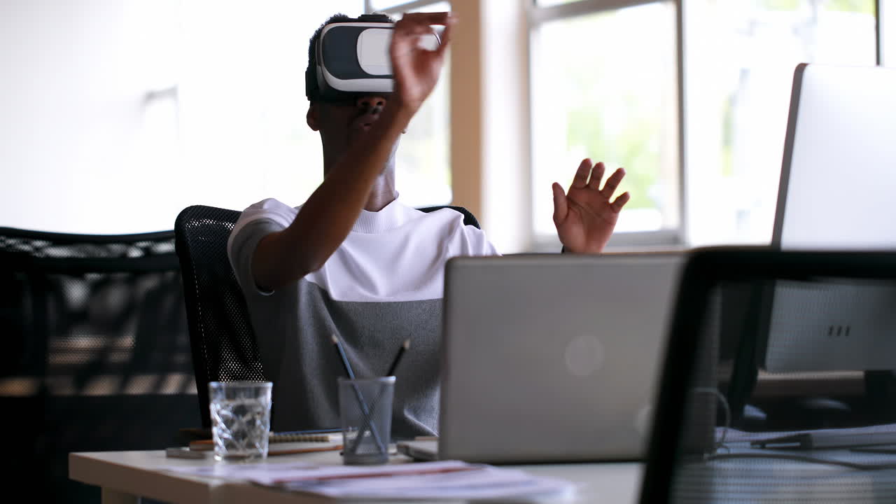 Male executive using virtual reality headset at desk 4k