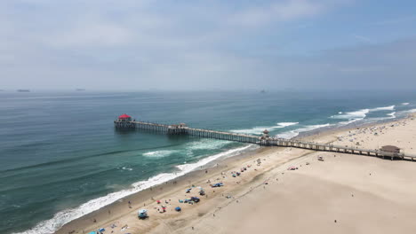 reverse dolly over huntington beach, california, view of mist covered pacific ocean
