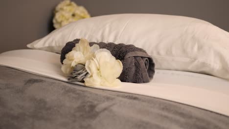 towel and flower on a cosy spa bed