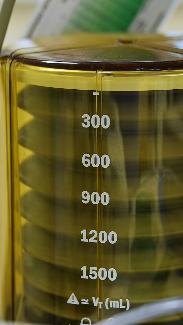 Machine pumping air to patient's lungs. Pulmoflator moving slowly during the surgical procedure. Close up. Vertical video