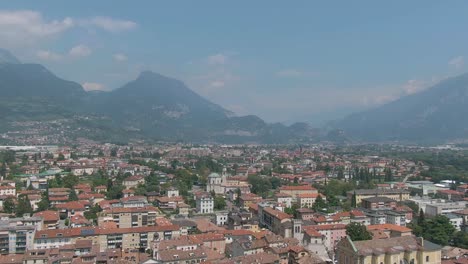 Aerial drone view of the beautiful Riva Del Garda town surrounded by the italian alps in the summer time, Trentino Alto Adige region, Lago Di Garda, North Italy