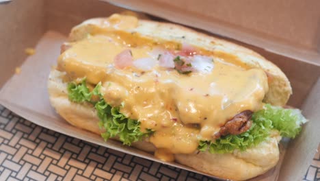 beef burger in a take away box on table