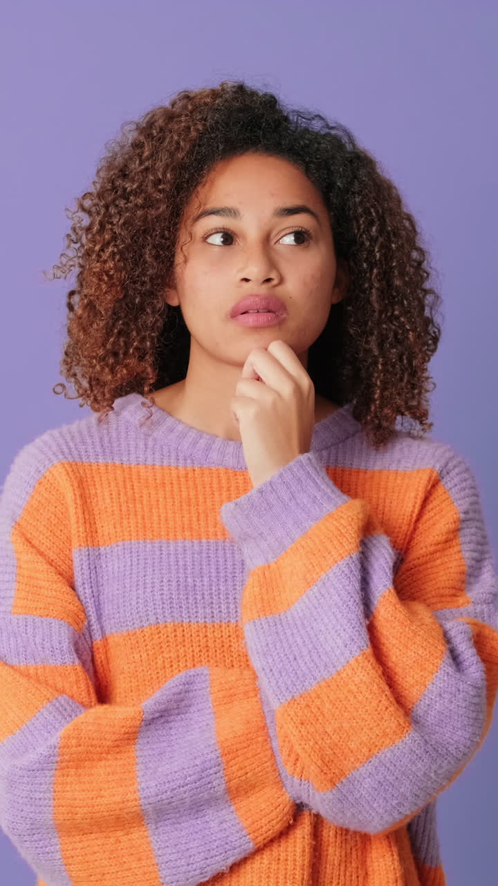 Thoughtful Young Woman Pondering and Smiling in Studio