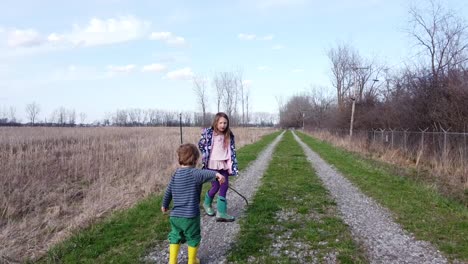 kids roaming and playing at the field in monroe, michigan under the bright blue sky - wide shot
