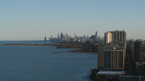 aerial footage of a wintery day north of chicago with lake michigan and downtown chicago skyline in the background