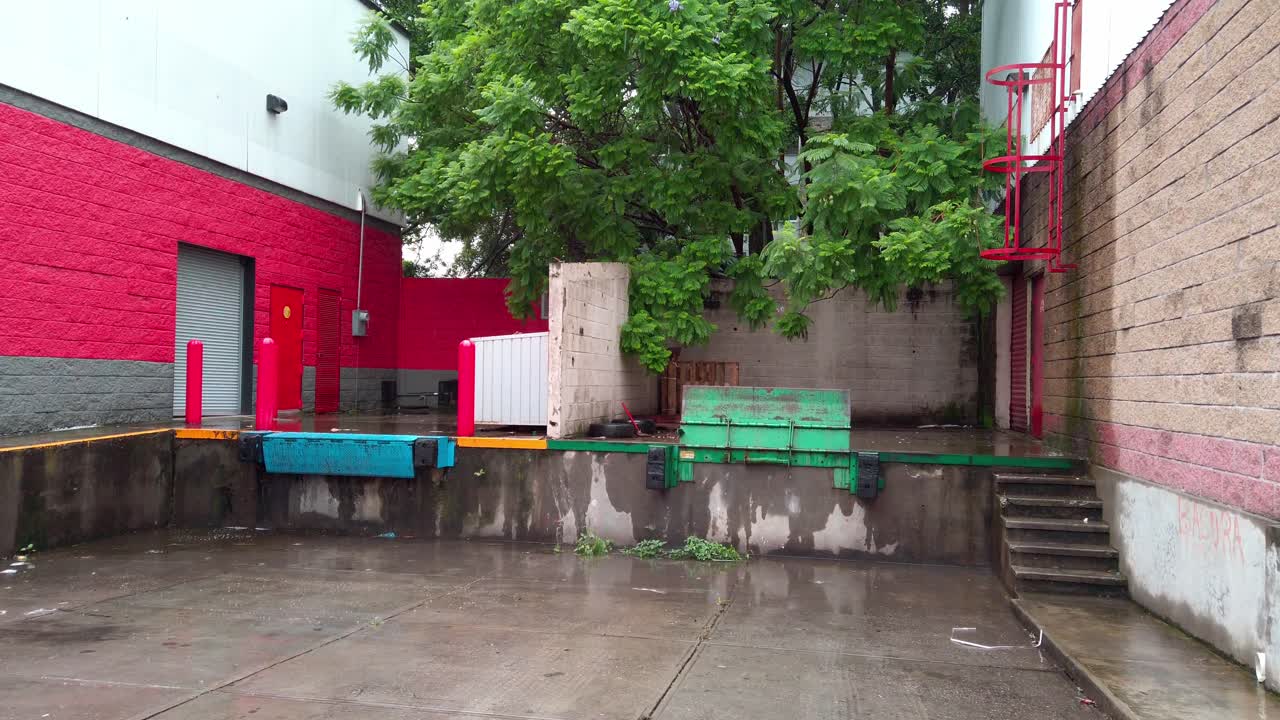 Industrial dock with loading gates and red painted walls on a wet concrete floor