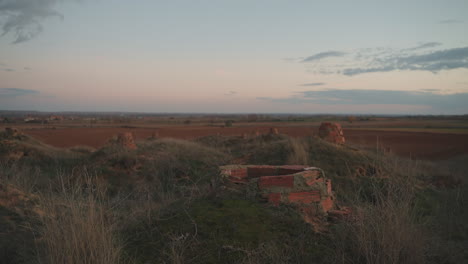 serene countryside with old brick structures and man amidst rural spain