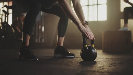 woman in gym with kettlebell