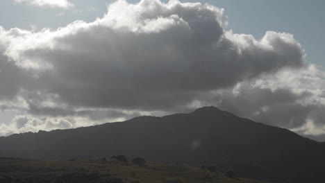 storm clouds pass over a hilly area