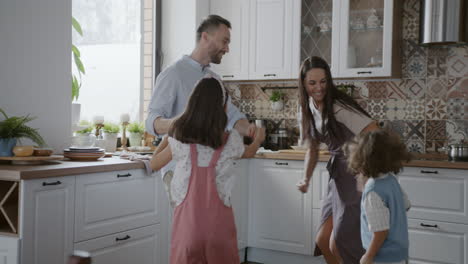 family dancing in the kitchen