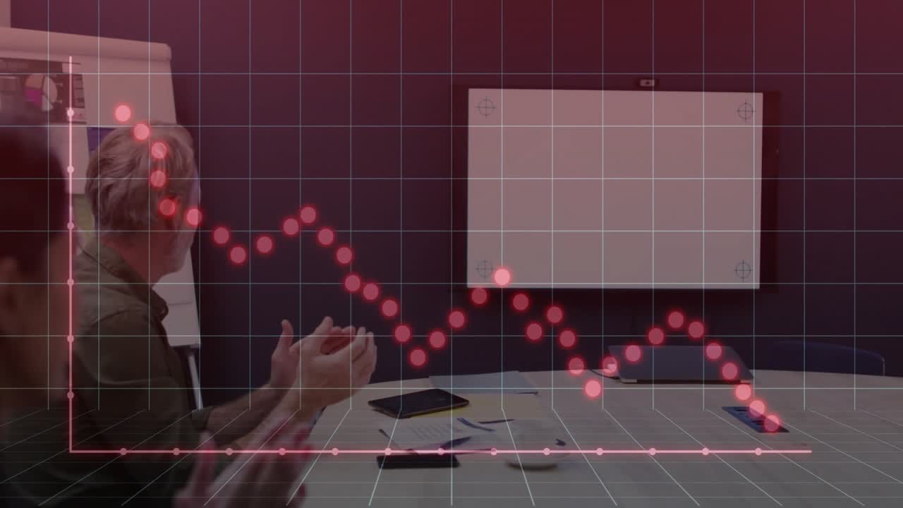 Business colleagues clapping hands in meeting room, showing red grid with downward data line