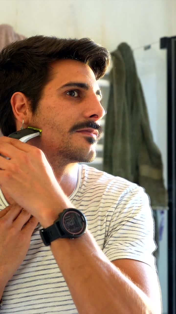 Man Grooming His Facial Hair with a Trimmer