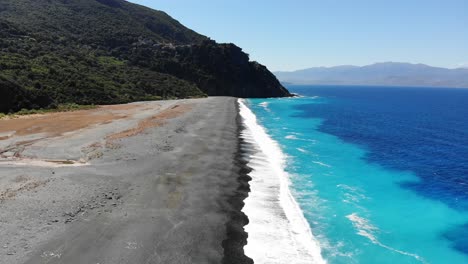 Slow-drone-flies-over-foreshore-Nonza-beach-in-Corsica-during-a-summer-day