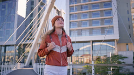 woman on a bridge in a city