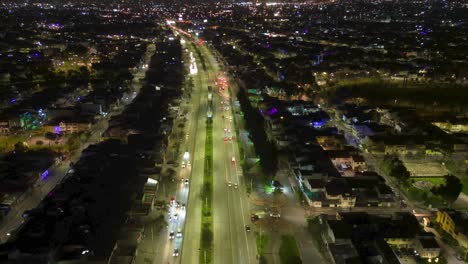 Aerial-hyperlapse-of-the-city-of-Bogota-at-night,-Transmilenio-transportation