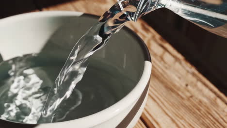 pouring water into a bowl