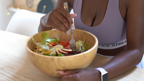 black woman eating healthy salad for lunch