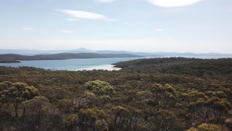 Drone-footage-flying-towards-green-island-beach