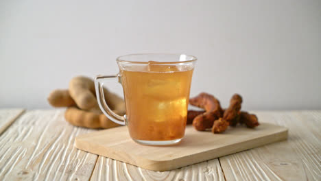 delicious sweet drink tamarind juice and ice cube - healthy drink style