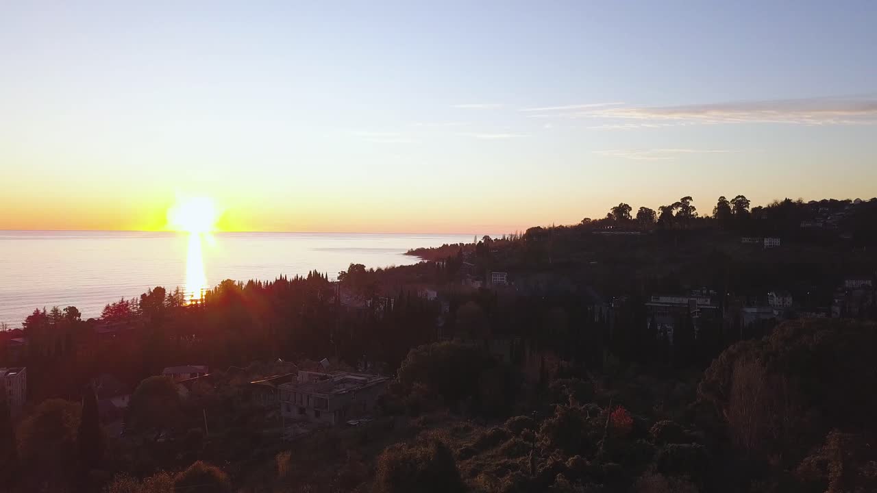 해안 도시 풍경 위의 해가 지는 모습