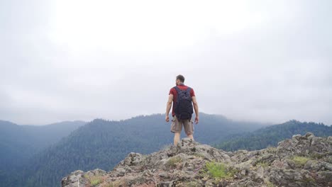 the man walking on the summit.  feeling of freedom.