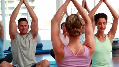 Happy-yoga-class-sitting-in-lotus-position-together