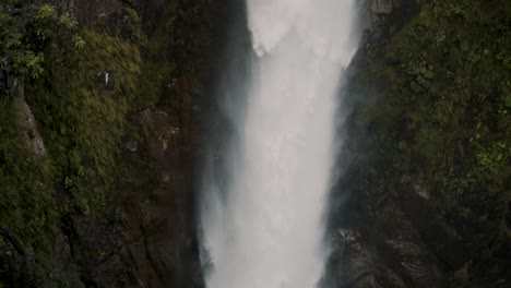 Tourists-At-The-Viewing-Deck-Of-Devil's-Cauldron-Waterfall-Near-Banos,-Ecuador