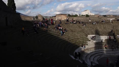 ancient pompeii, italy amphitheater with people exploring and video panning right to left