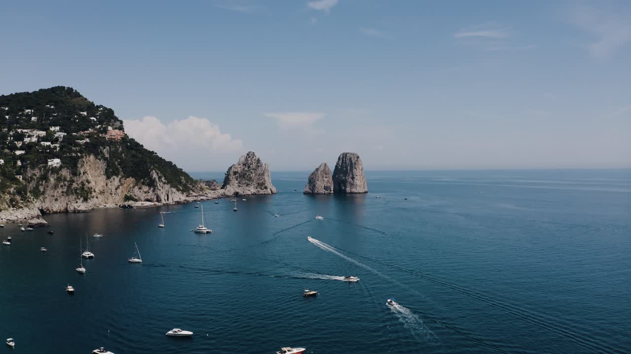 Drone shot of boats cruising through Italy's coastal waters