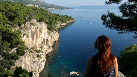 woman on epic journey with breathtaking mountain top sea view