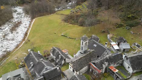 approaching drone shot slightly strafing to the left anove above the village of cavergno, in the district of vallemaggia, bordering italy in the canton of ticino, in switzerland