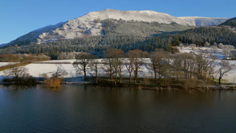 elevarse sobre el lago bassenthwaite hasta colinas nevadas en el distrito inglés de los lagos