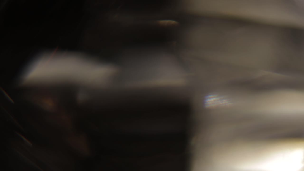 Multicolored light leaks 4k footage on black background. Stylizing video, transitions. Bokeh effect