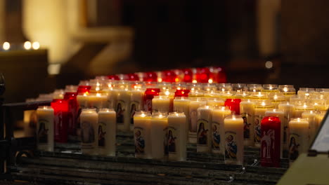 burning sacrificial candles in sacre coeur basilica in montmartre, paris france