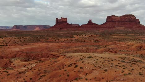 Aerial-dolly-forward-over-red-sand-desert-at-border-of-Utah-and-Arizona