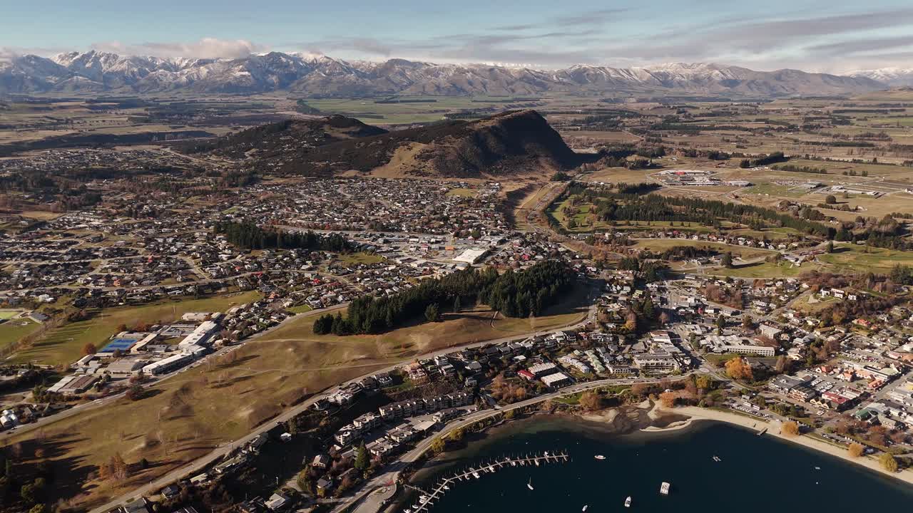 High birds eye view of Wanaka Town and surrounding landscape with mountains and lake