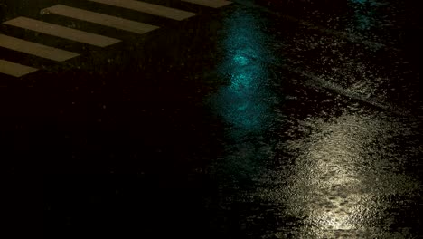 cars passing a crossroads during heavy rain with city light reflections