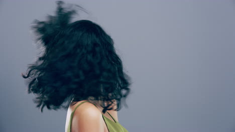 a young woman dancing against a grey background